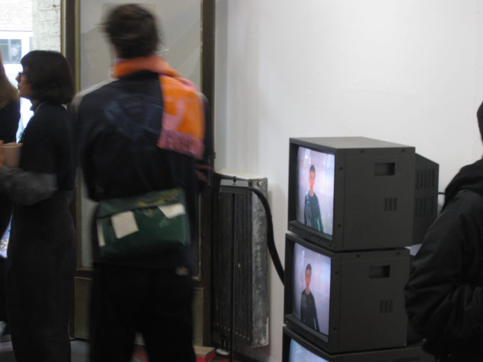 Visitors in front of the stacked CRT televisions at the exhibition WIR SEHEN ROT!! by dings.