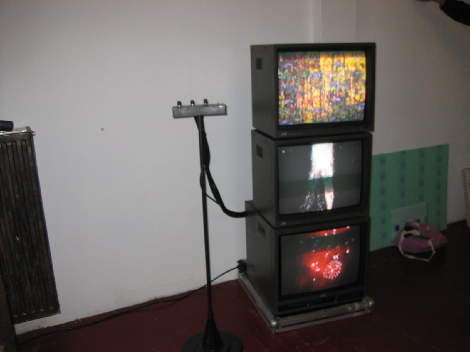 "Gefühle": three stacked CRT televisions showing glitched video, with the potentiometer stand visitors turn to mix the image.